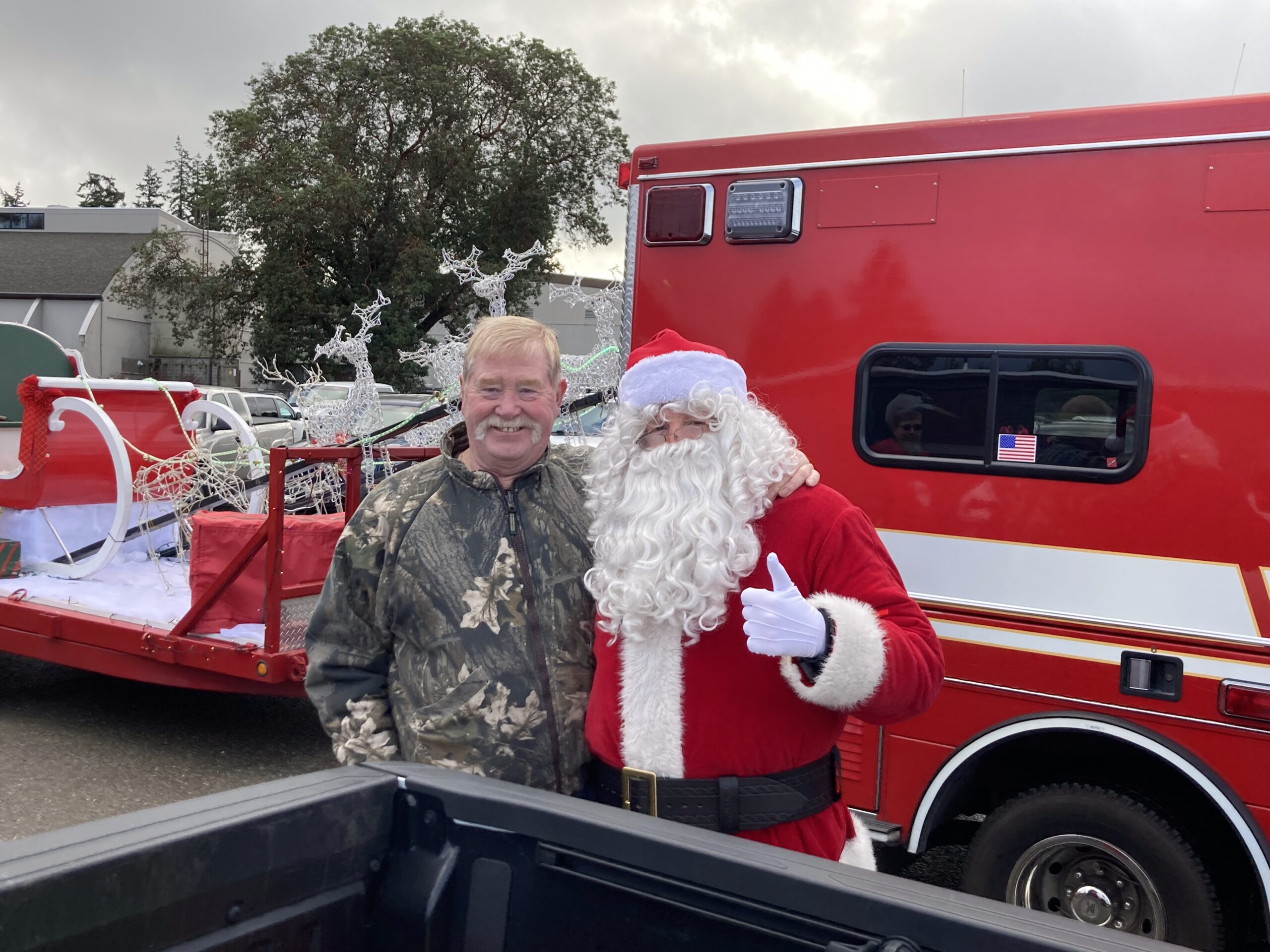 Barney Mills with Santa at Holly Jolly Parade